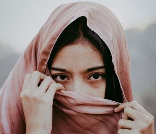 A girl made to wear a mask to cover her face, either as per traditions or to avoid getting stared at