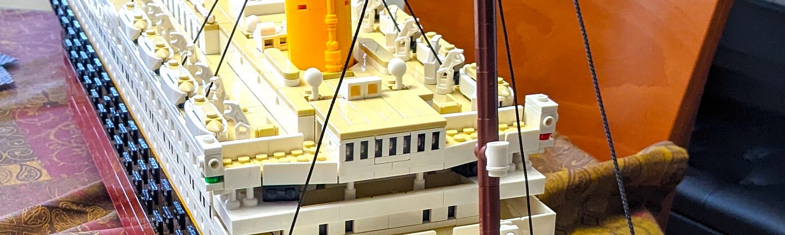 RMS Titanic ship model created out of LEGO pieces displayed on a dining room table.