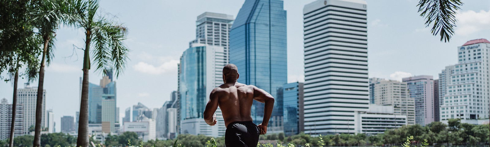 Muscular man jogging in the suburbs