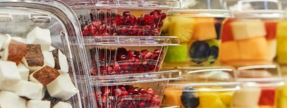 Fruit in plastic containers on a supermarket shelf