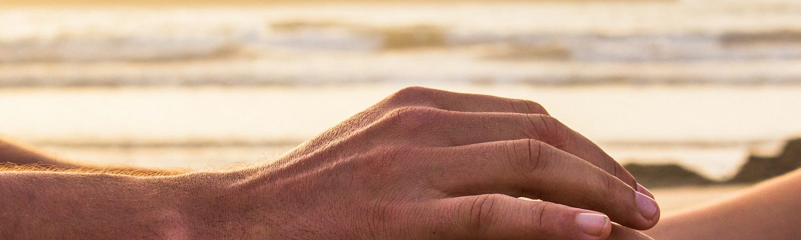 Two person holding hands in a calm and supporting way