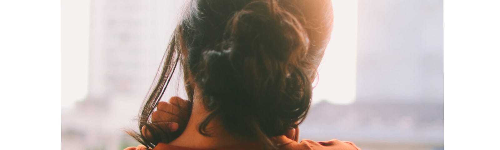 A backshot of a woman in her balcony