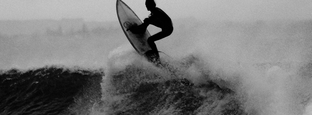 Monochrome surfer on wave
