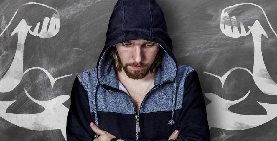 Man with his arms crossed and with super arms drawn in chalk behind him