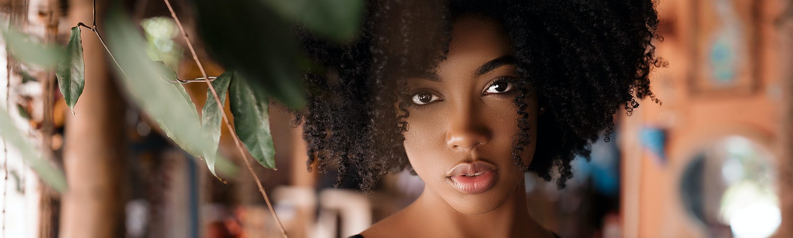 Picture of Black woman standing in front of window.