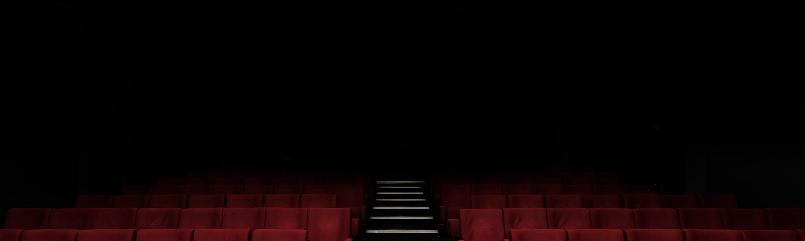 Looking up cinema stairs at the seats.