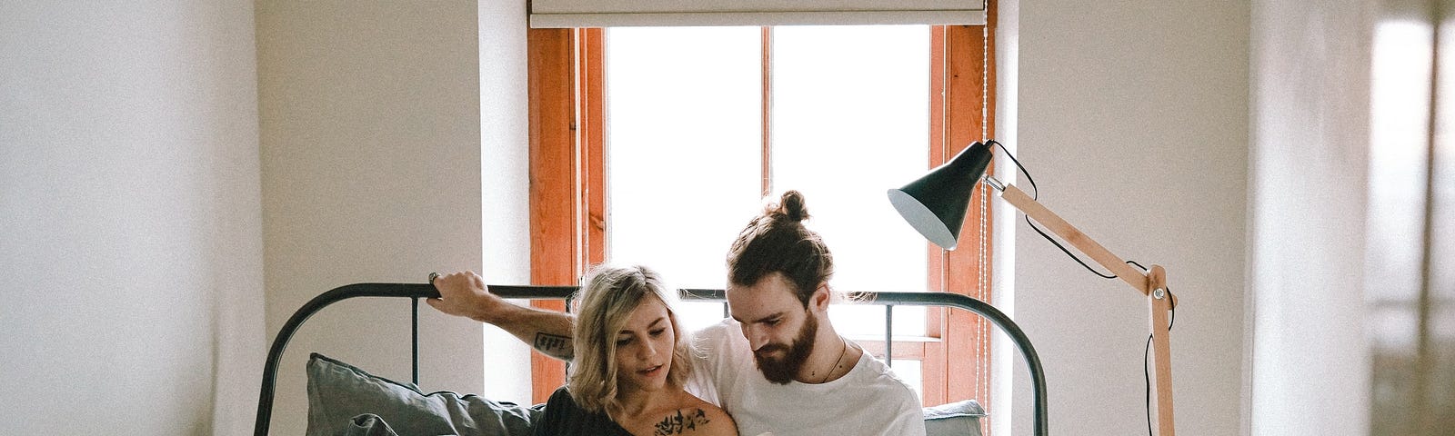 Two people reading in bed.