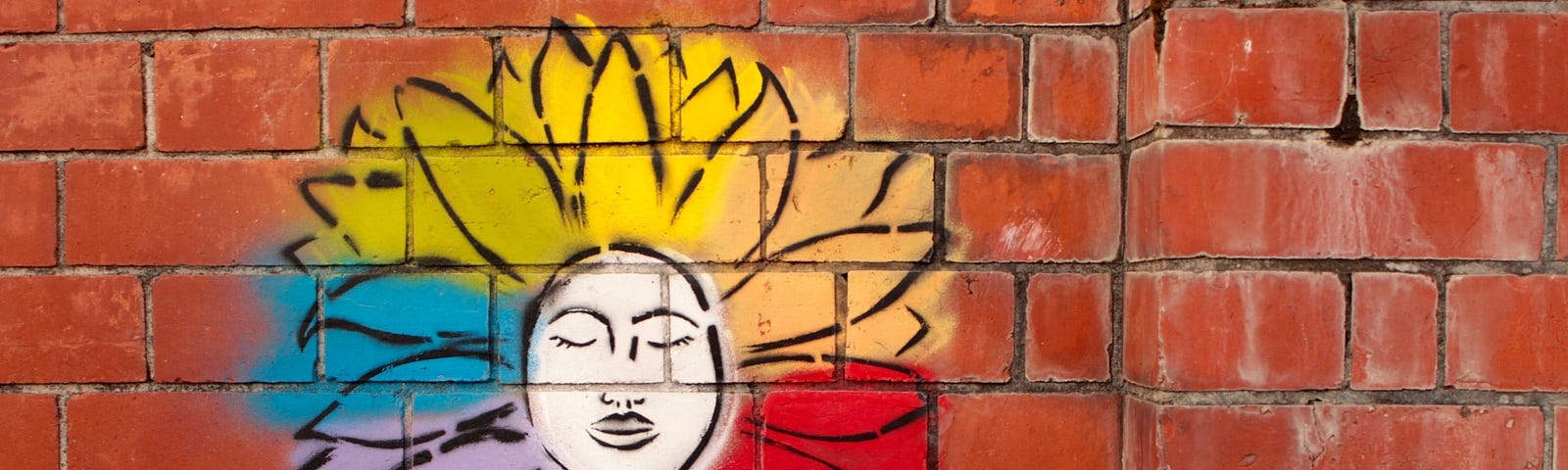 Street art of a female figure with rainbow hair.