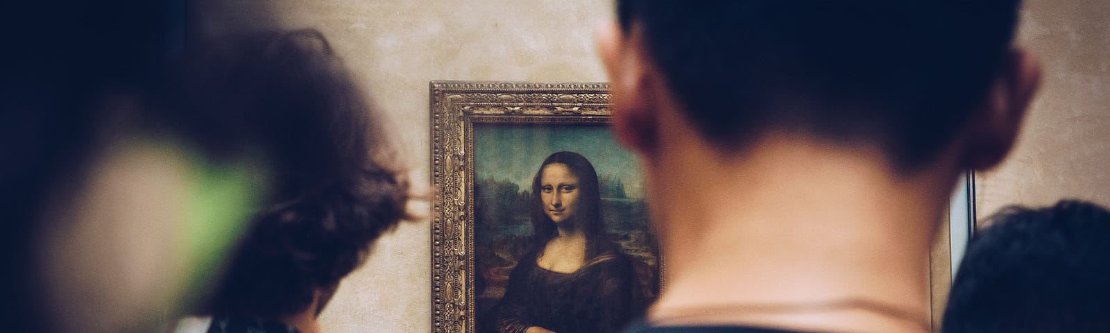 A group of museum visitors looking at the Mona Lisa.