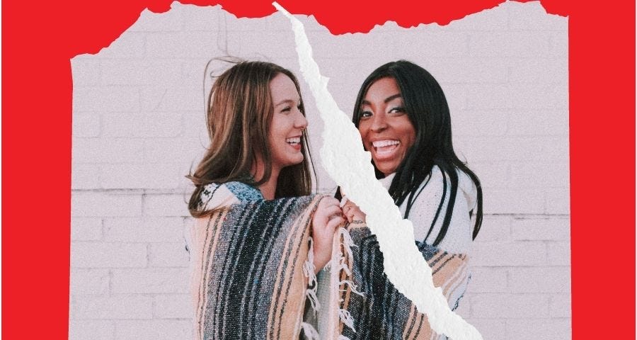 A white woman and black woman laughing, sharing blanket, photo torn