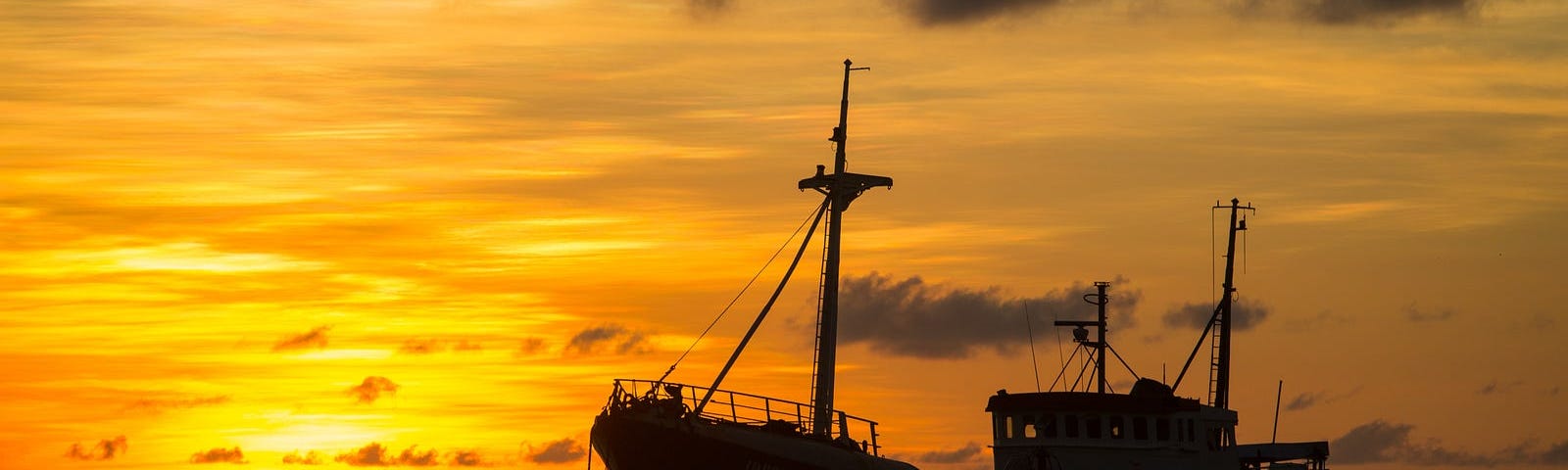 A freighter anchored at sunset