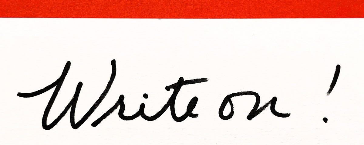 A handwritten note card that says “Write on!”