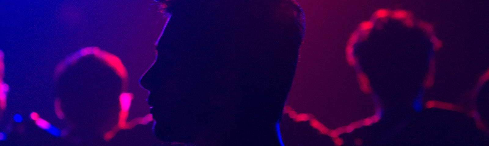 Young guy in the shadows of a nightclub