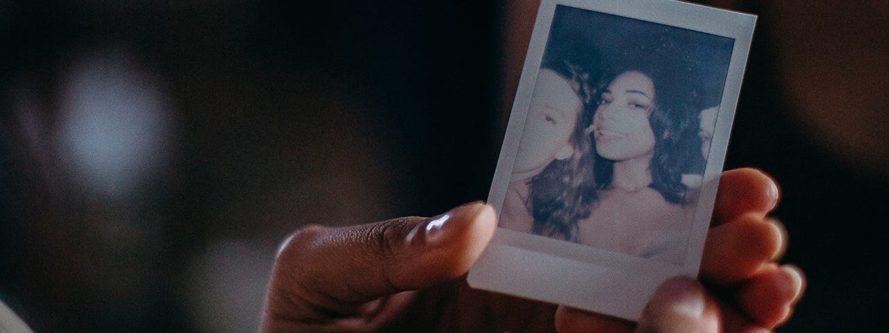 Person holding woman’s photo