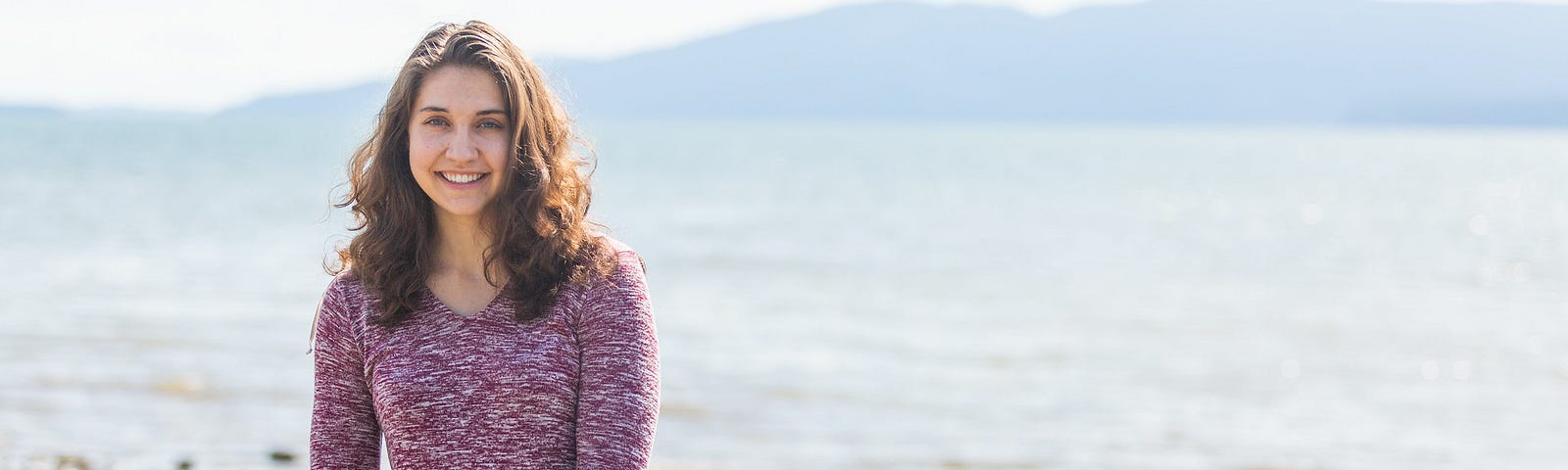 Darby on a beach with Lummi Island behind her