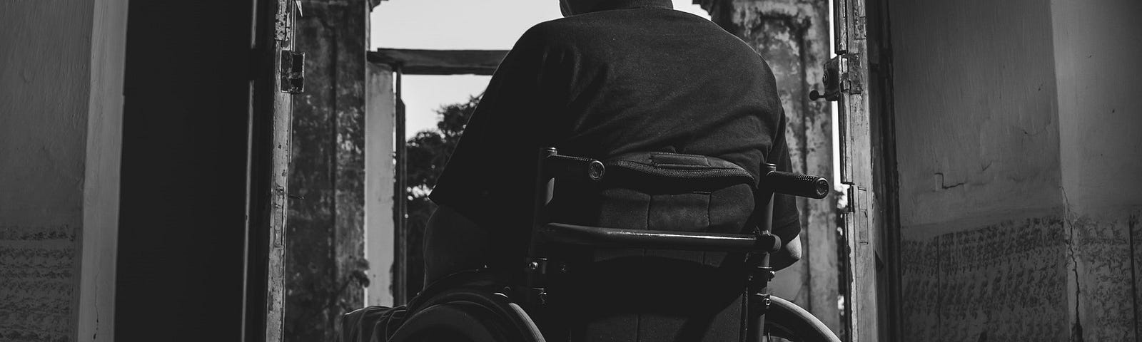 An elderly on a wheelchair alone.