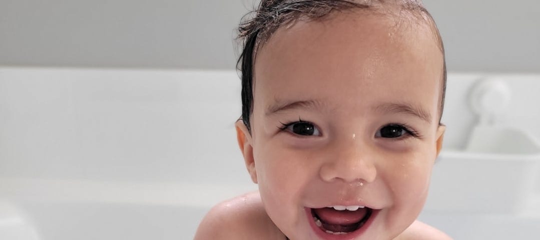 Milo smiling in the bath