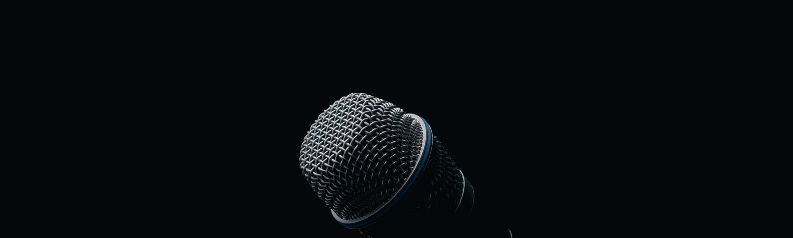 A microphone on a stage with a black background