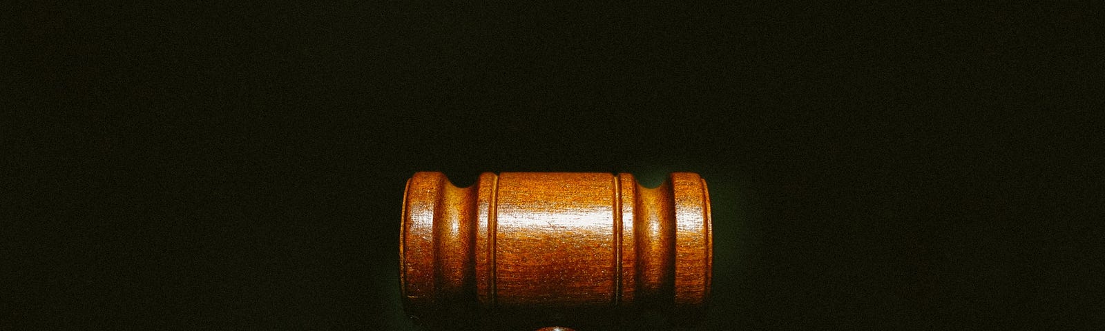 An image of a gavel against a black background