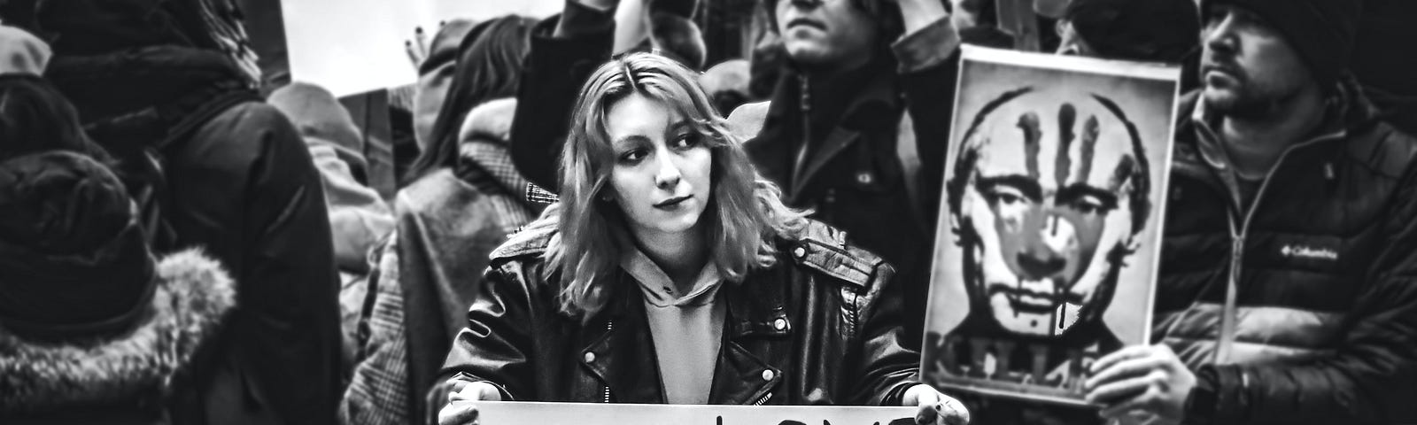 A Woman Holding a Make Love Not War Sign