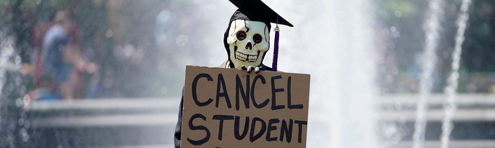 An individual with a “Cancel Student Debt” sign.