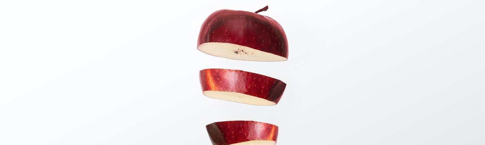 A red apple sliced up.