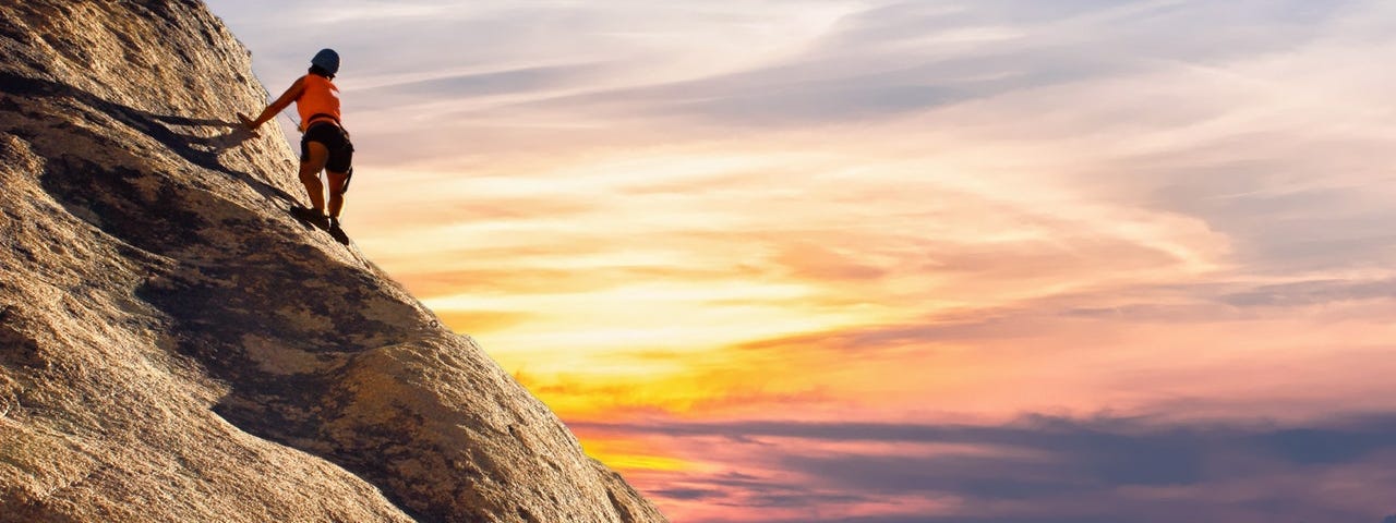 person climbing a mountain