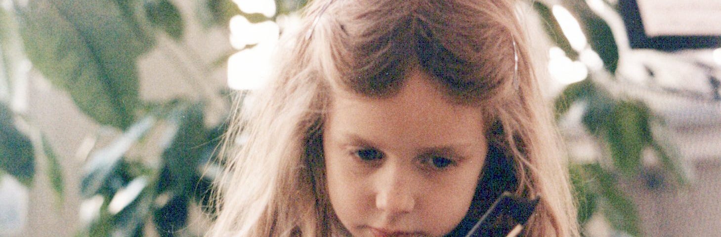 A young girl is playing the violin