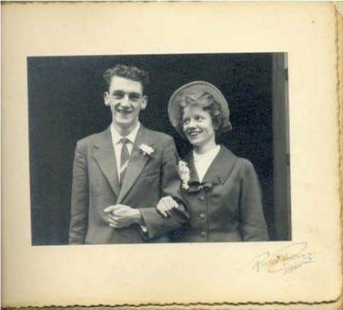 black and white picture of John Tennent and Mary Tennent on their wedding day, John is in a suit with a buttonhole, Mary is in a formal outfit with a flower buttonhole and a hat. John is smiling at the camera, Mary is smiling up at him. Photo belongs to Alison Tennent The garrulous glaswegian Medium