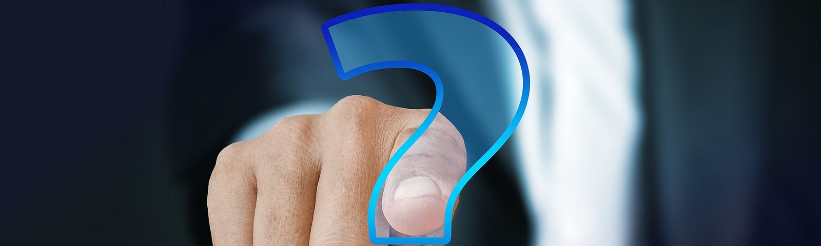 A person pointing a finger into a blue question mark