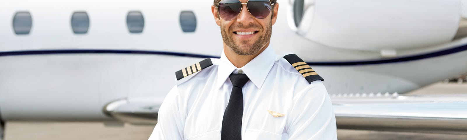 Sexy, male private jet captain. Depositphotos.