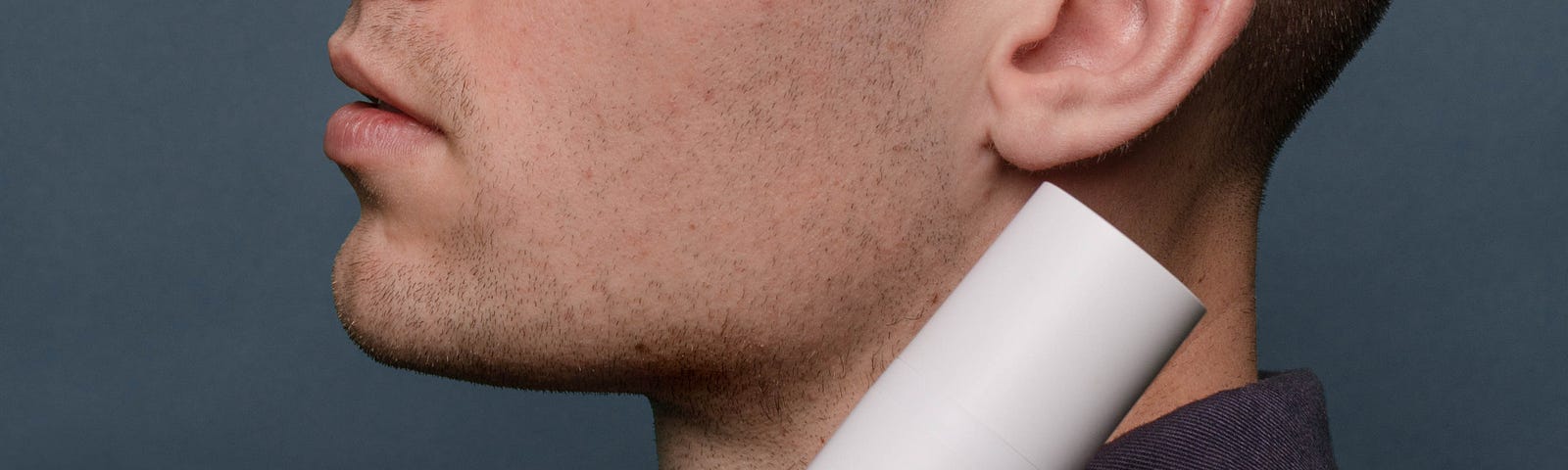 Close-up of man’s face with Curology superbottle skin treatment