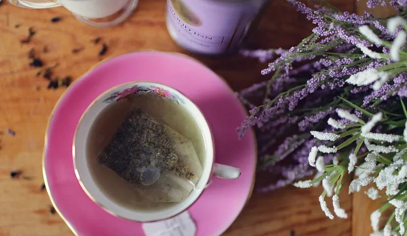 Tea bag brewing in a pretty teacup. Image courtesy Leah Newhouse via Pixabay