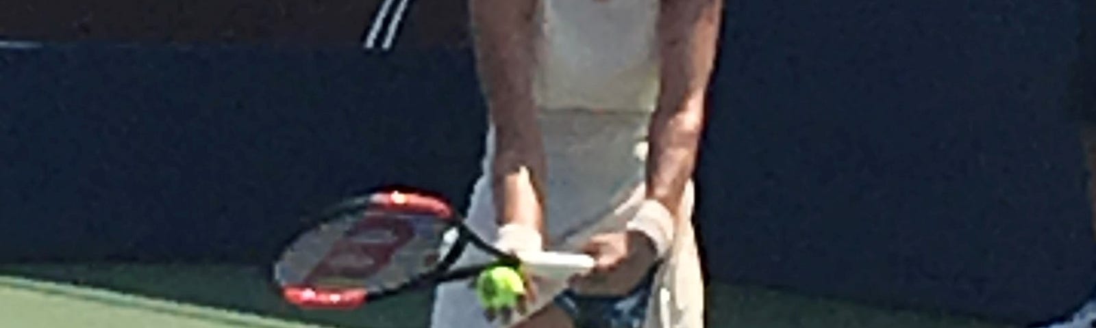 Photo of myself preparing to serve a tennis ball.