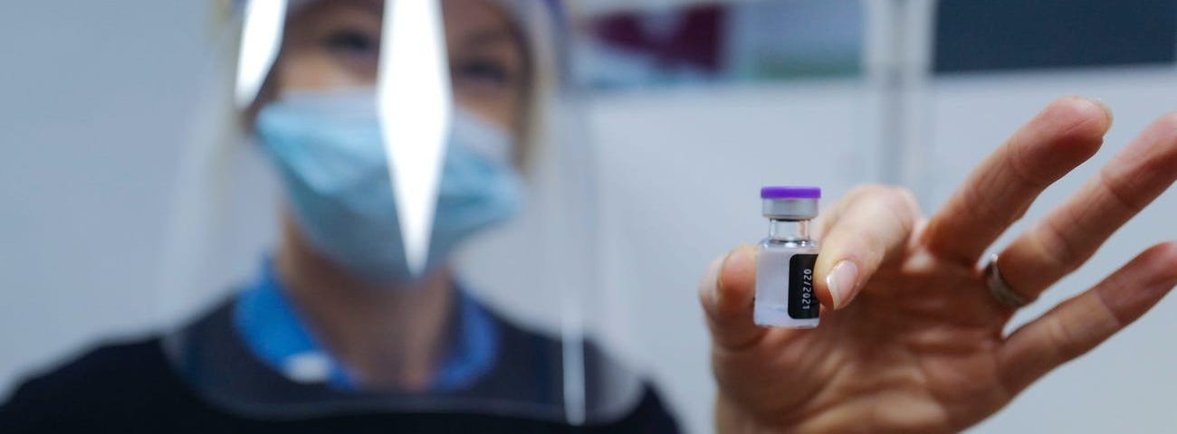 A nurse at the Royal Cornwall Hospital prepares to administer a COVID-19 vaccine in Truro, United Kingdom.