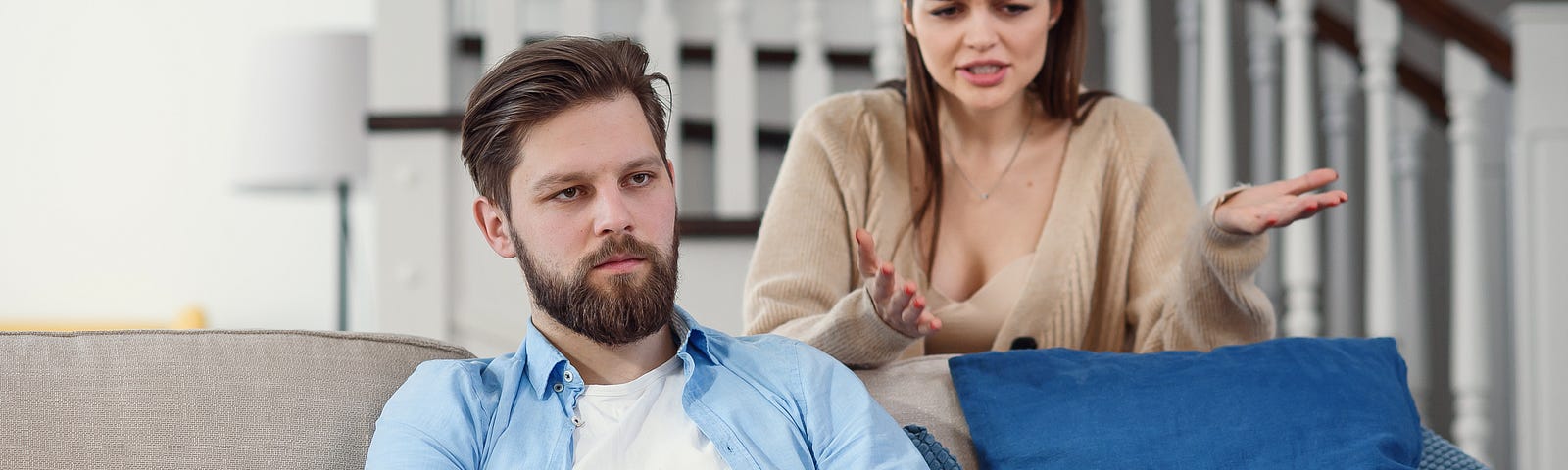 confused-man-sits-couch-while-his-girlfriend-yells-quarrels-with-him-home-big-family-problems — Un Swede