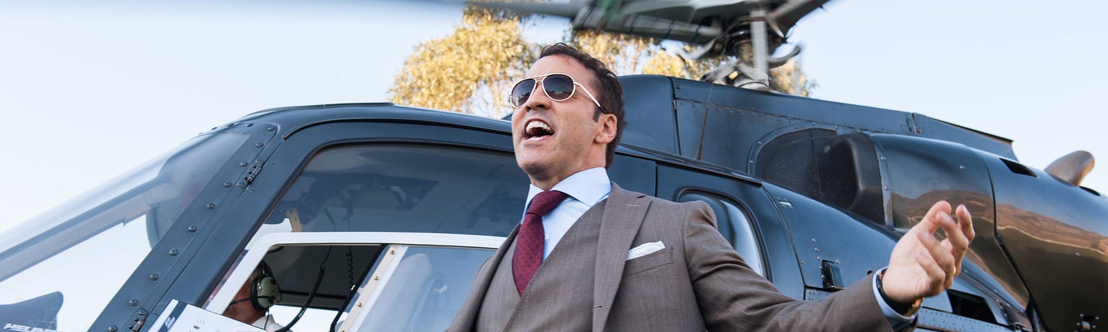 Jeremy Piven, acting as Ari Gold in Entourage, steps boldly from a helicopter.