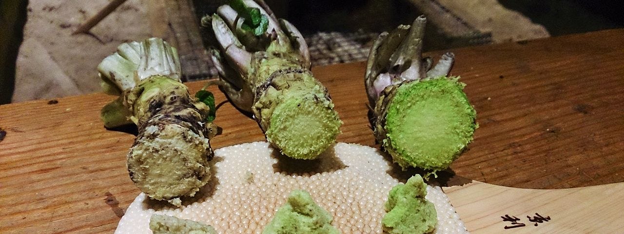 Three regional varieties of fresh wasabi, root and grated