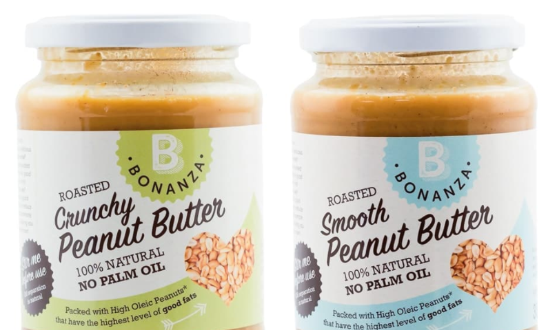 Two jars of no palm oil peanut butter in front of a white background