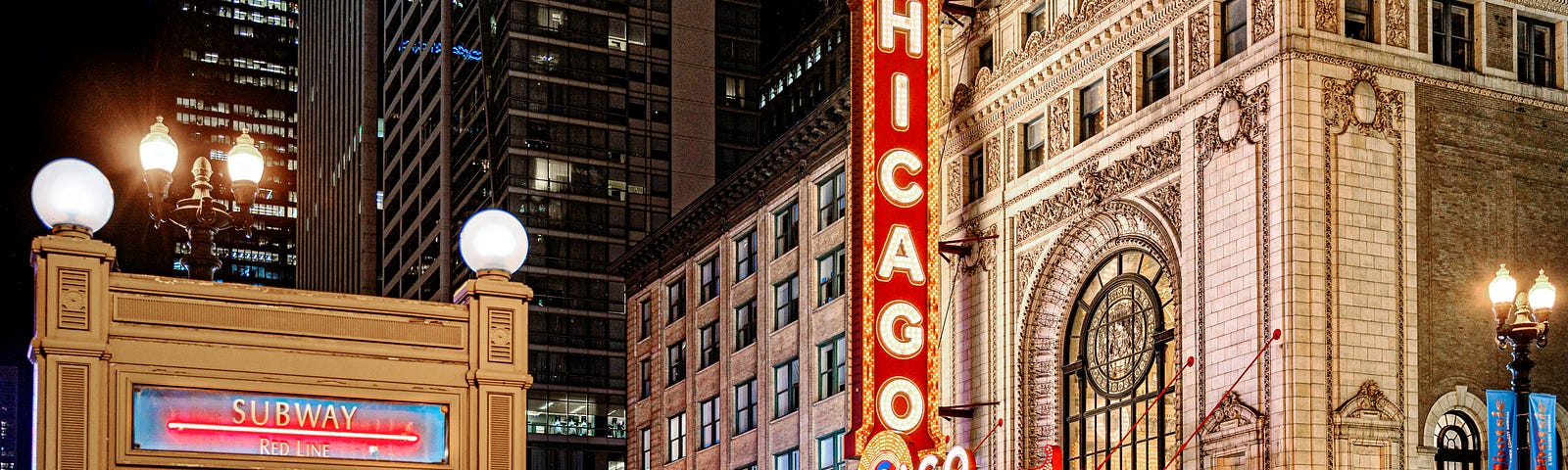 Chicago Theater and subway stop lit up with neon lights at night