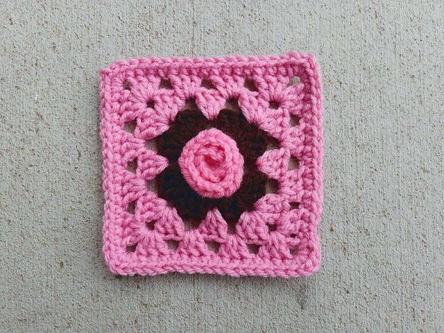 A crochet rosette at the center of a granny square
