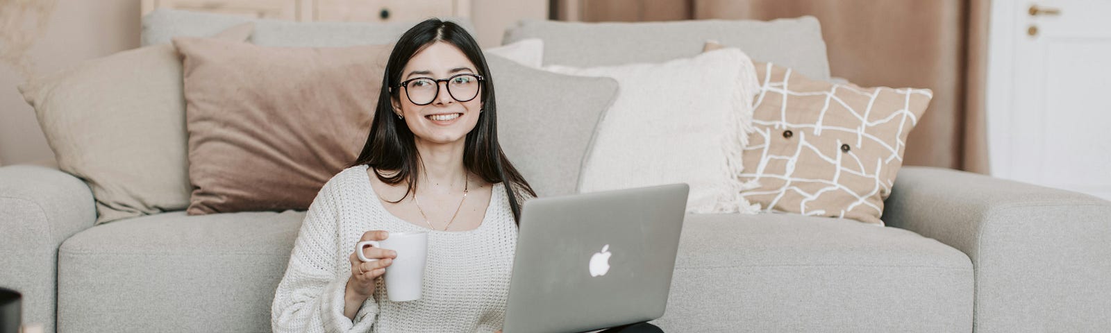 Cheerful woman using laptop at home