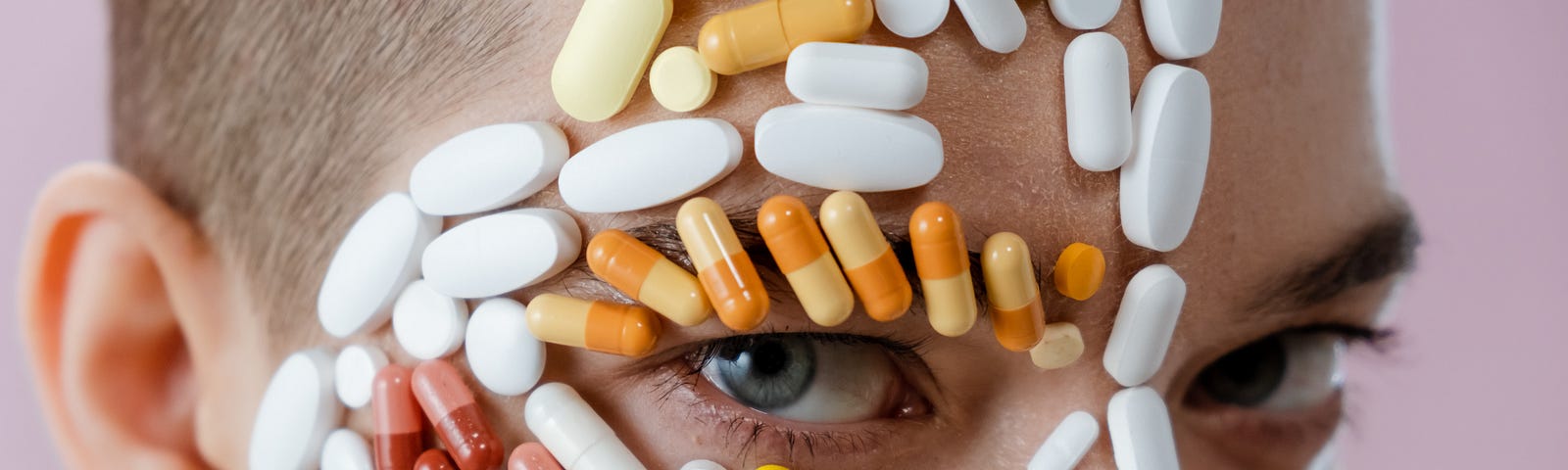 Woman with a variety of pills stuck to her face.