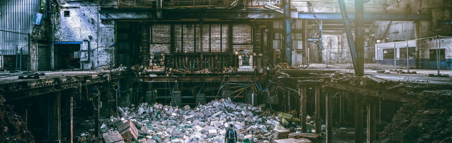 semi-destroyed building full of debris from collapsed roof and walls