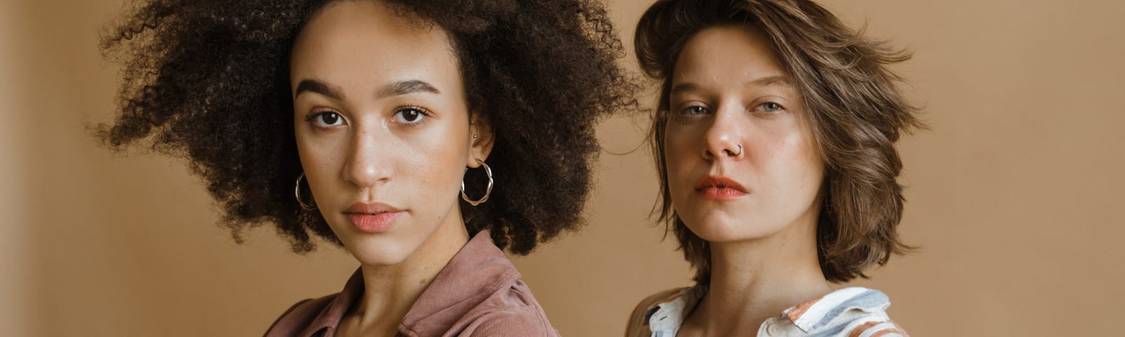 Two women looking at the camera. Fatunla Samuel (Women’s Day Should Be Celebrated a Lot Less).