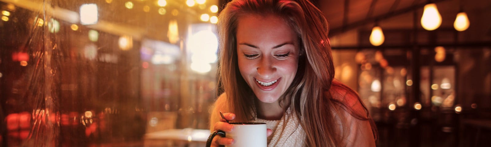 A smiling woman in a coffee shop