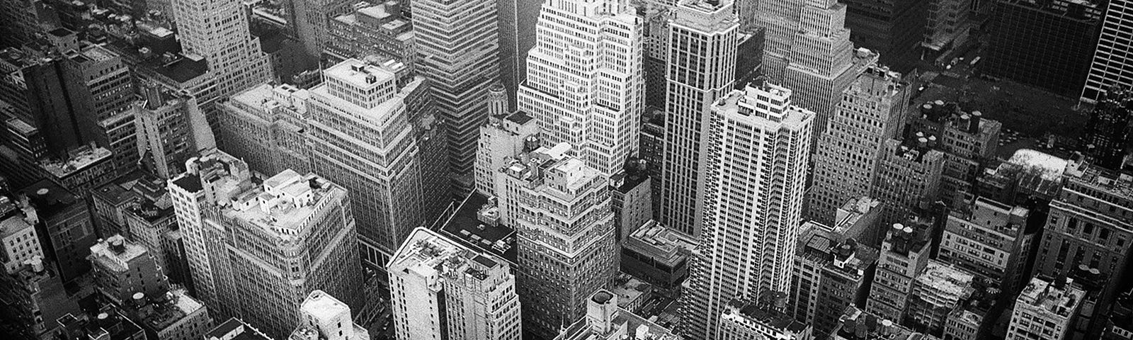Aerial View and Grayscale Photography of High-rise Buildings