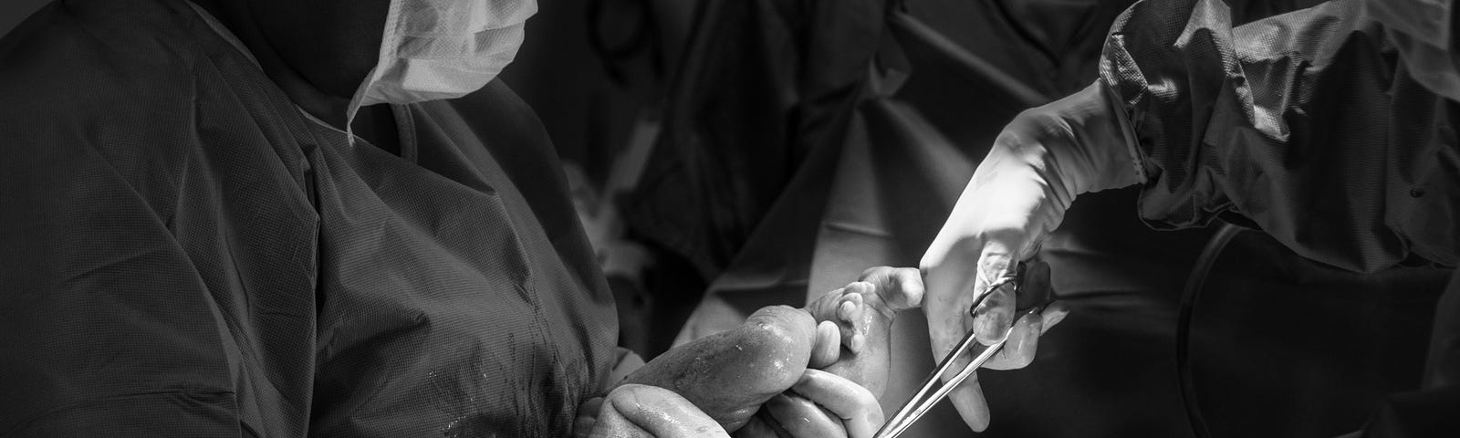 Photo of surgeons with baby by Jozemara Friorili Lemes