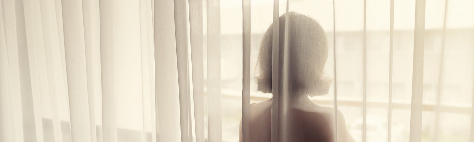 Woman standing in front of a window