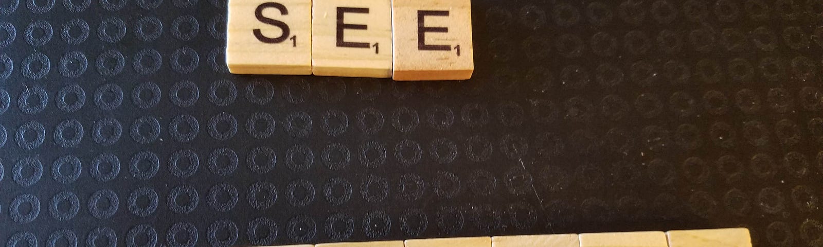 wooden tiles spelling out “see yourself”